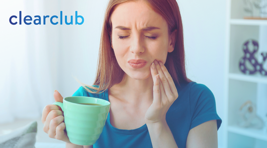 Woman with tmj pain holding a coffee