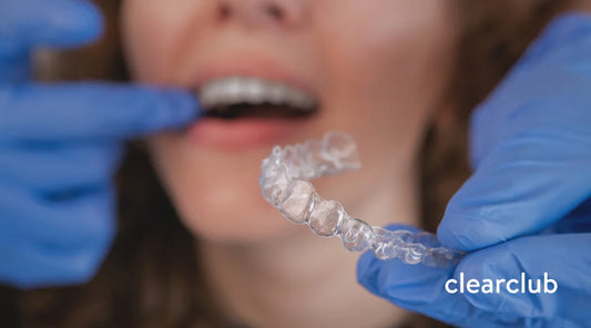 Dentist evaluating misaligned teeth caused by a retainer that no longer fits properly