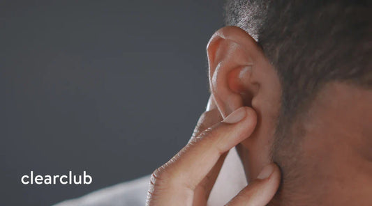 Man holding his ear due to ear ringing from possible tinnitus linked to bruxism