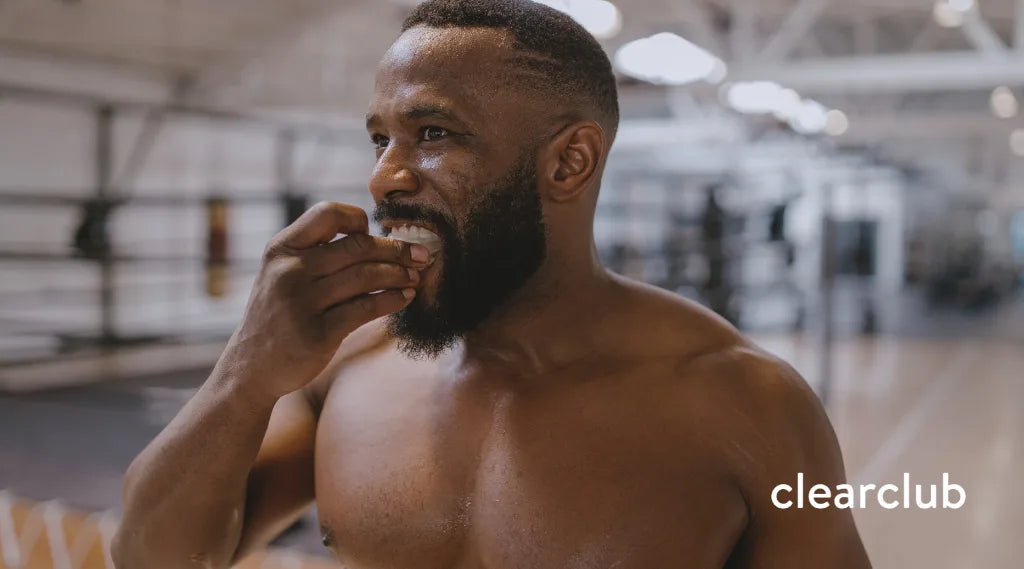 Athlete checking the fit of his sports mouthguard to see if it needs replacing.