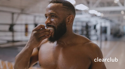 Athlete checking the fit of his sports mouthguard to see if it needs replacing.