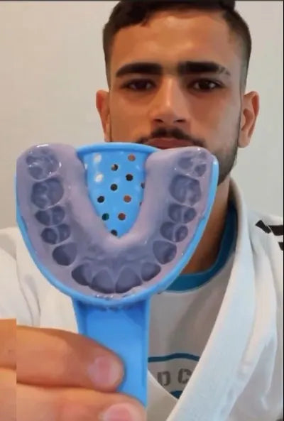 BJJ athlete using a custom sports mouth guard during a competition