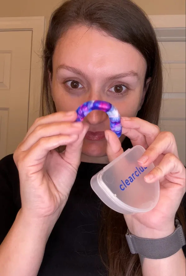 holding a custom mouth guard color bubble gum