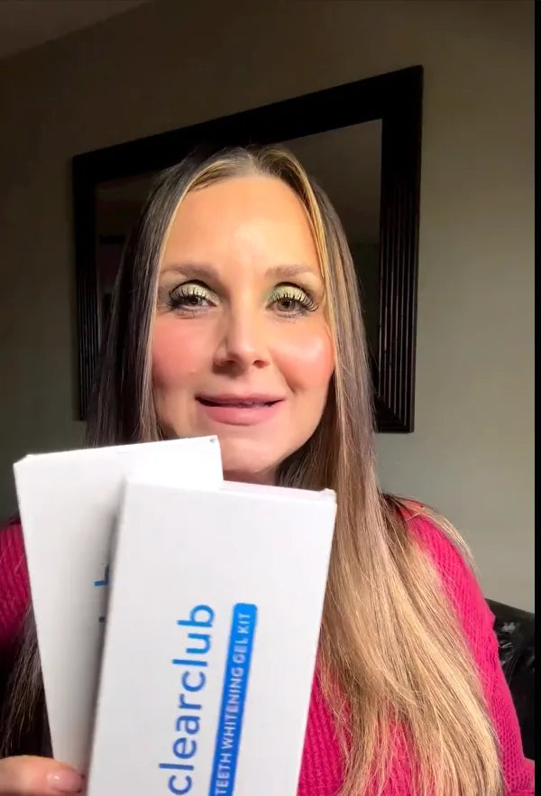 holding two boxes of whitening gel