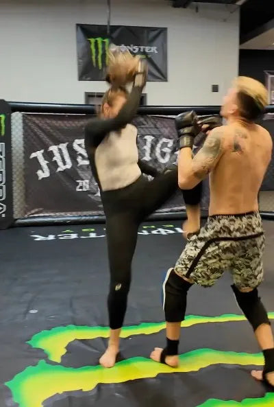 MMA fighter with a custom-fit sports mouthguard training in the gym