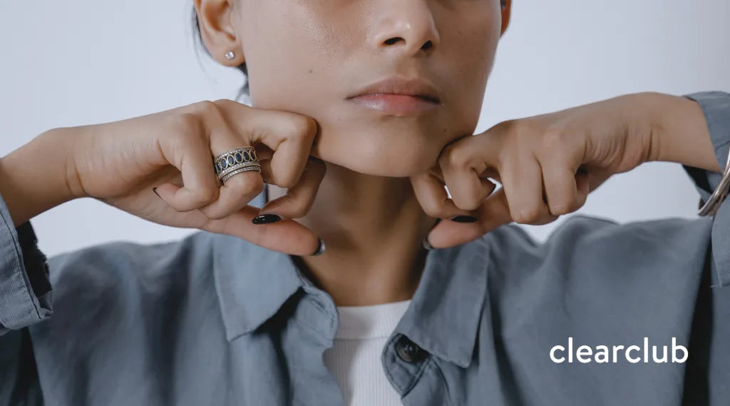 Woman performing a jaw massage exercise to help relieve bruxism-related jaw tension