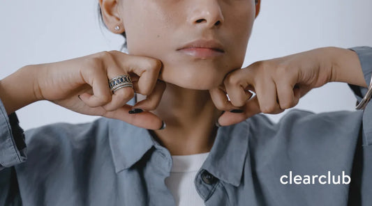 Woman performing a jaw massage exercise to help relieve bruxism-related jaw tension