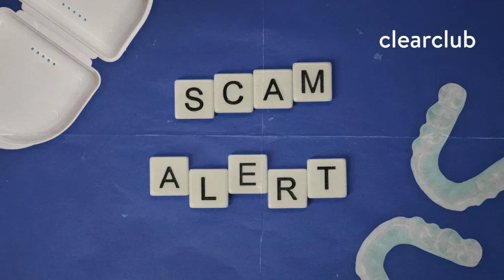 A dental guard case, two custom night guards, and Scrabble tiles spelling “scam alert” on a textured blue background