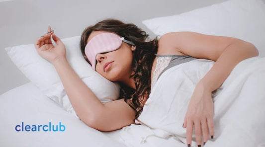 Woman sleeping on her side with her arm resting on a pillow, illustrating a sleeping position that may affect jaw comfort and teeth grinding.