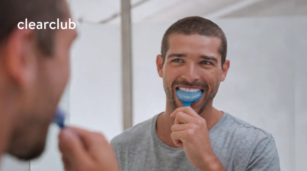 Man taking a dental impression in front of a mirror