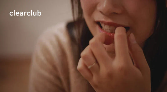 Woman biting her nails, a habit associated with teeth grinding