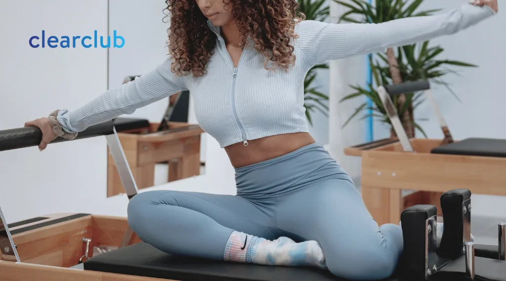 Woman practicing Pilates to improve posture and ease neck and shoulder tension that may contribute to jaw discomfort.