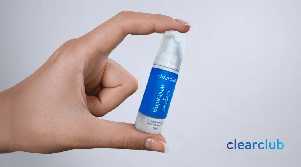 A person holding ClearClub's Cleaning + Whitening Foam bottle.