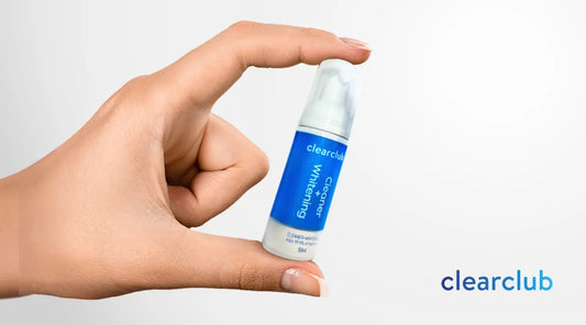 A person holding ClearClub's Cleaning + Whitening Foam bottle.