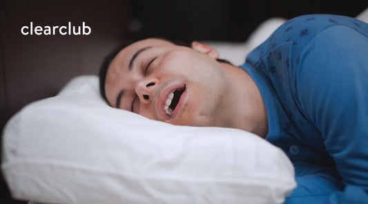 Man sleeping with his mouth open, showing a common example of nighttime mouth breathing
