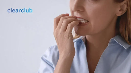 Woman biting her nails, which may transfer bacteria from her nails to her mouth
