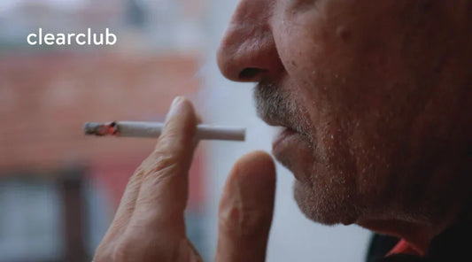 Man holding a cigarette near his mouth, illustrating smoking and its potential link to bruxism.