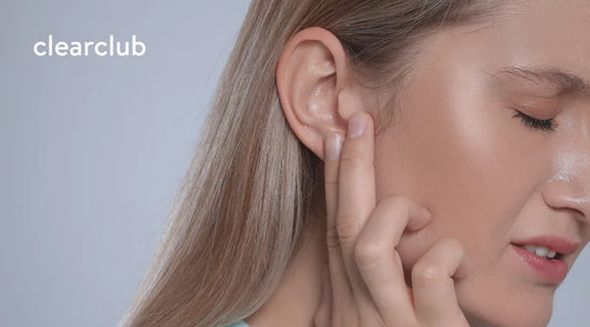Woman touching the area between her ear and jaw due to discomfort.