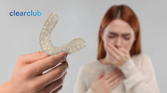 Woman reacting to bad breath while a man holds a smelly retainer nearby.
