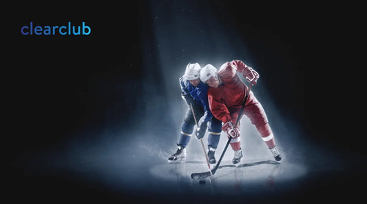 Ice hockey players clash for the puck, highlighting risk of dental injuries.