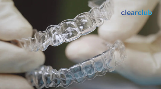 Two clear night guards for bruxism displayed side by side.