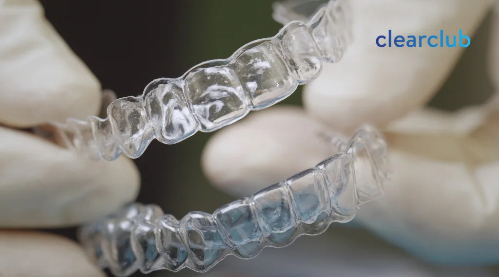 Two clear night guards for bruxism displayed side by side.