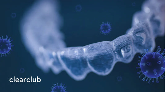 A clear plastic night guard surrounded by bacteria buildup.