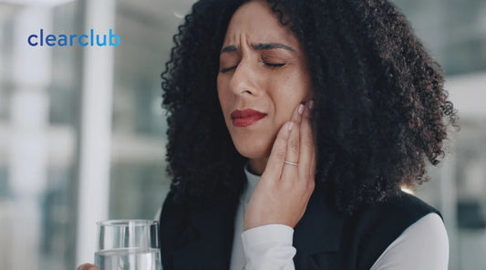 Woman touching her cheek in discomfort from sensitive teeth