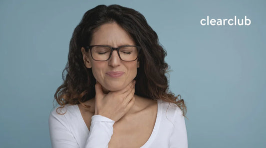 Woman holding her throat due to discomfort after teeth whitening