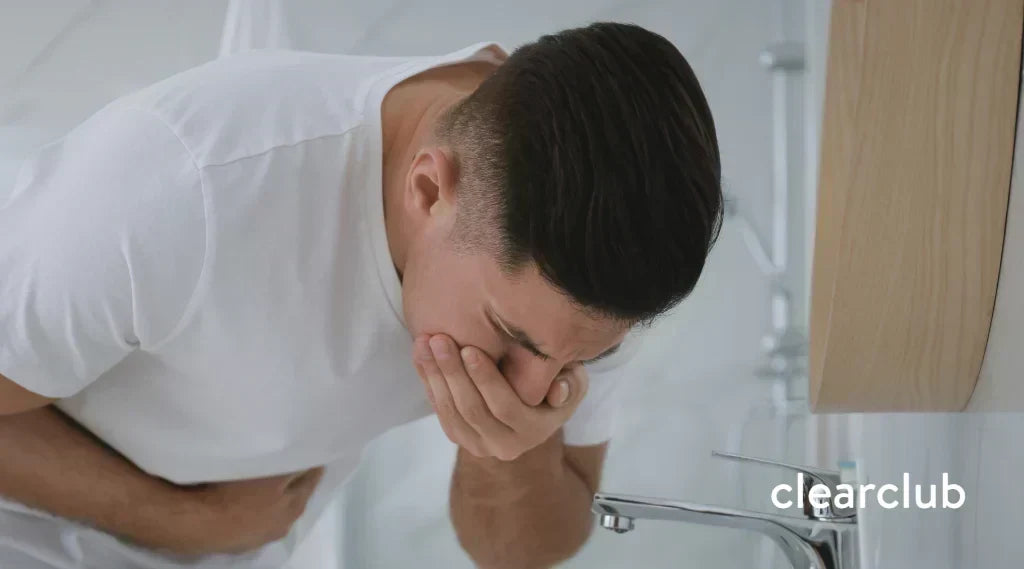 Man gagging while wearing a mouthguard