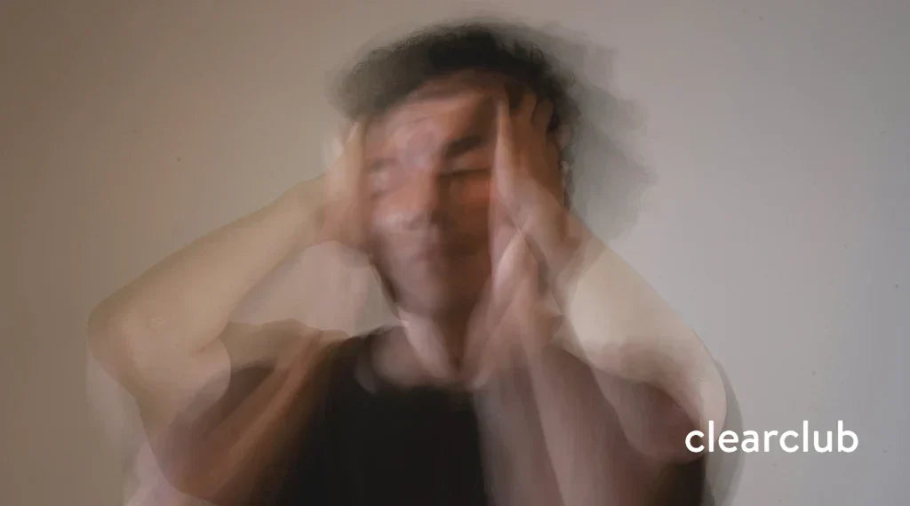 Man clutching head in pain from stress, sleep apnea, and teeth grinding