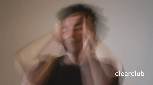 Man clutching head in pain from stress, sleep apnea, and teeth grinding