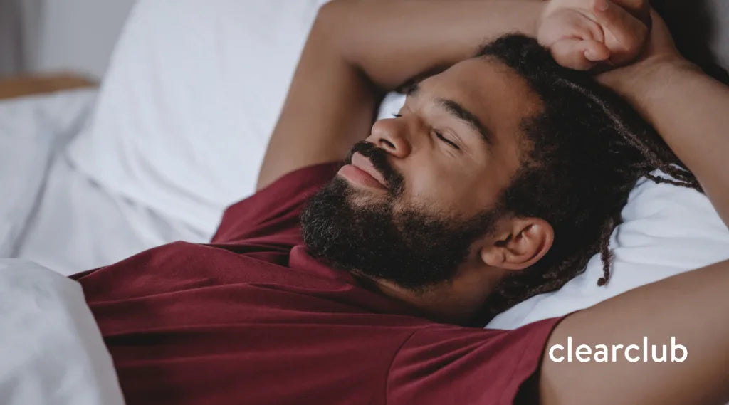 Athlete asleep in bed, possibly wearing a sports guard meant for daytime use